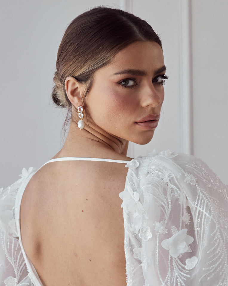 double quartz gemstone with baroque pearl earrings by Lola Knight - at Kezani - on model with hair in a bun looking over shoulder