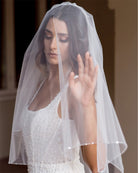 wedding and bridal veils - elegant elbow length veil with extra sparkle crystal edge - two tier - on model with dark hair - with face veil - Demi at Kezani