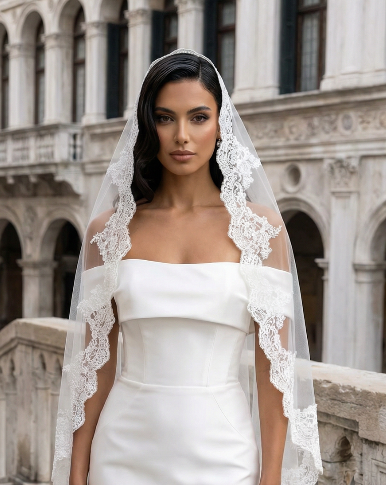 bride with dark hair wearing short lace edge mantilla wedding veil in Venice a Kezani