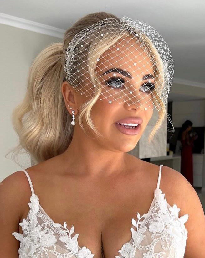 wedding earrings - dainty crystal cascade with pearl drop on model with birdcage veil - isobel by johnny b at Kezani