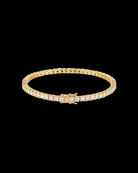 Gold bracelet with crystals on a black background