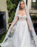 model standing in garden - italian vibe - off shoulder wedding gown with dramatic deep lace border veil in italian tulle - 3.5 metre cathedral style veil - chiara wedding veil at Kezani