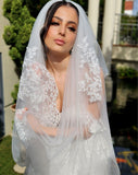 model wearing dramatic lace border cathedral style veil draped around her - full italian tulle - 3.5 metres long - chiara veil at Kezani