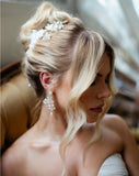soft updo with blonde hair - wearing pearl and lace luxury hair vine and pearl pin with pearl flower earrings - galia lahav gown and tulle gloves