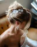 soft kim k updo with blonde hair - wearing pearl and lace luxury hair vine and pearl pin with pearl flower earrings - galia lahav gown and tulle gloves - higher view