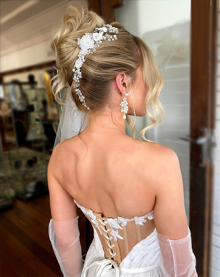 soft kim k updo with blonde hair - wearing pearl and lace luxury hair vine and pearl pin with pearl flower earrings - galia lahav gown and tulle gloves - side back view