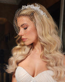 side view of birdcage veil on model with glam wave hair
