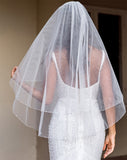 wedding and bridal veils - elegant elbow length veil with extra sparkle crystal edge - two tier - on model with dark hair - back view - Demi at Kezani