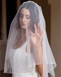 wedding and bridal veils - elegant elbow length veil with extra sparkle crystal edge - two tier - on model with dark hair - with face veil - Demi at Kezani