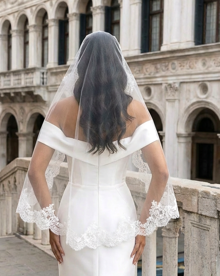 back view of bride wearing short lace edge mantilla wedding veil in Venice at Kezani