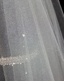 Bridal and wedding Veil  - two tier raw cut glimmer tulle with scatter diamonte in fingertip length - close up - at Kezani