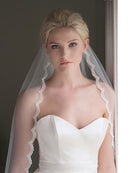 Bride in her white wedding gown with a white scallop lace edge veil called "Beauty" from Kezani jewellery.